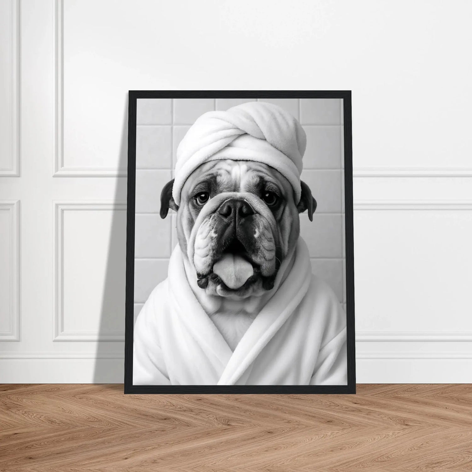 Lustiges Tierportrait einer englischen Bulldogge im Wellness-Stil mit Bademantel und Handtuch auf Fine-Art Papier im schwarzen Bilderrahmen 30x40 cm. Von vorne an einer Wand lehnend.